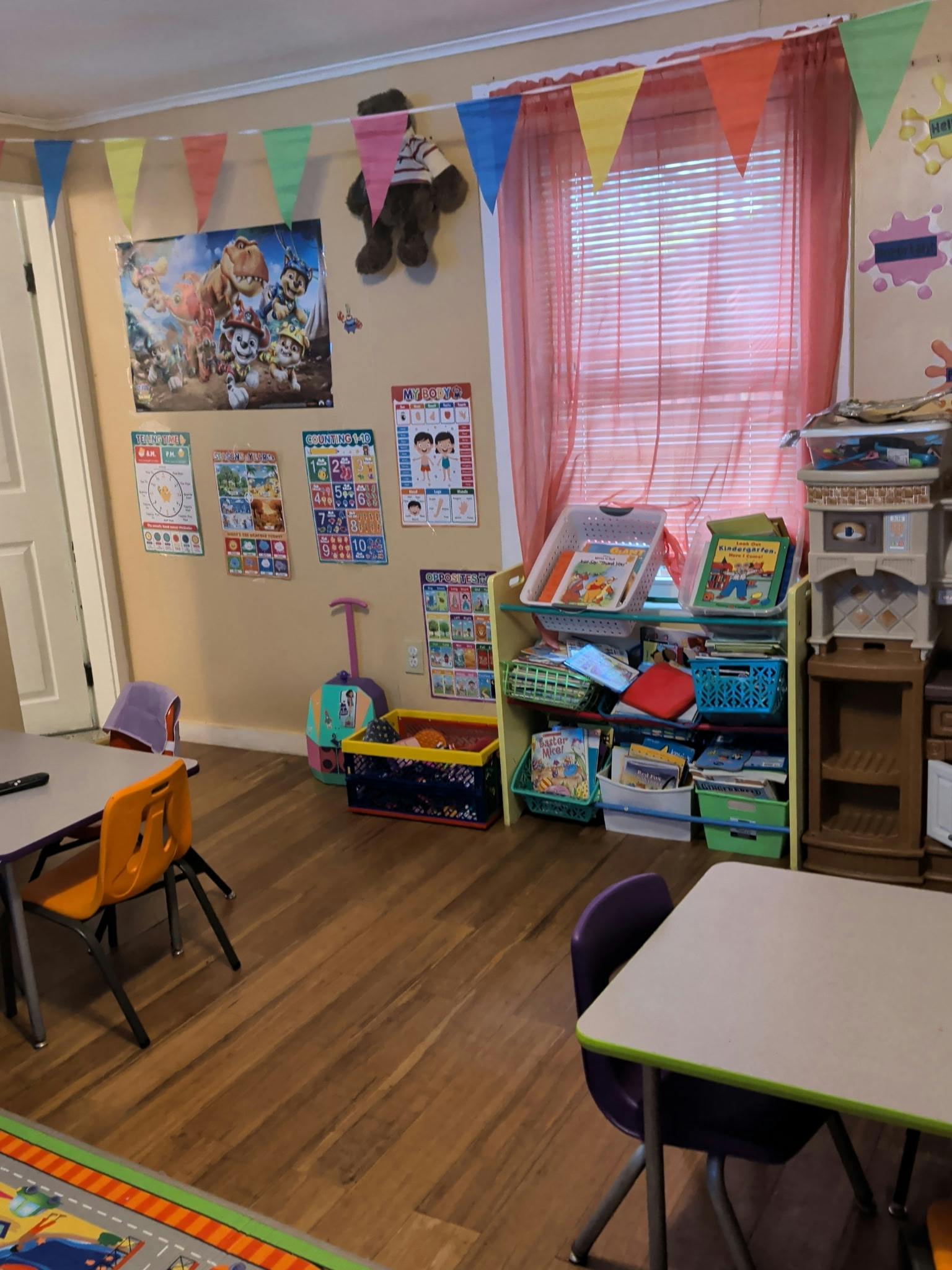 Educational posters and bookshelf with books in a classroom setting