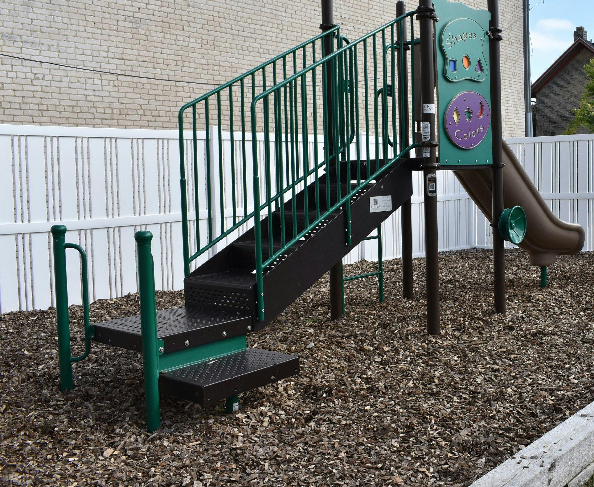 Playground structure with stairs and a slide