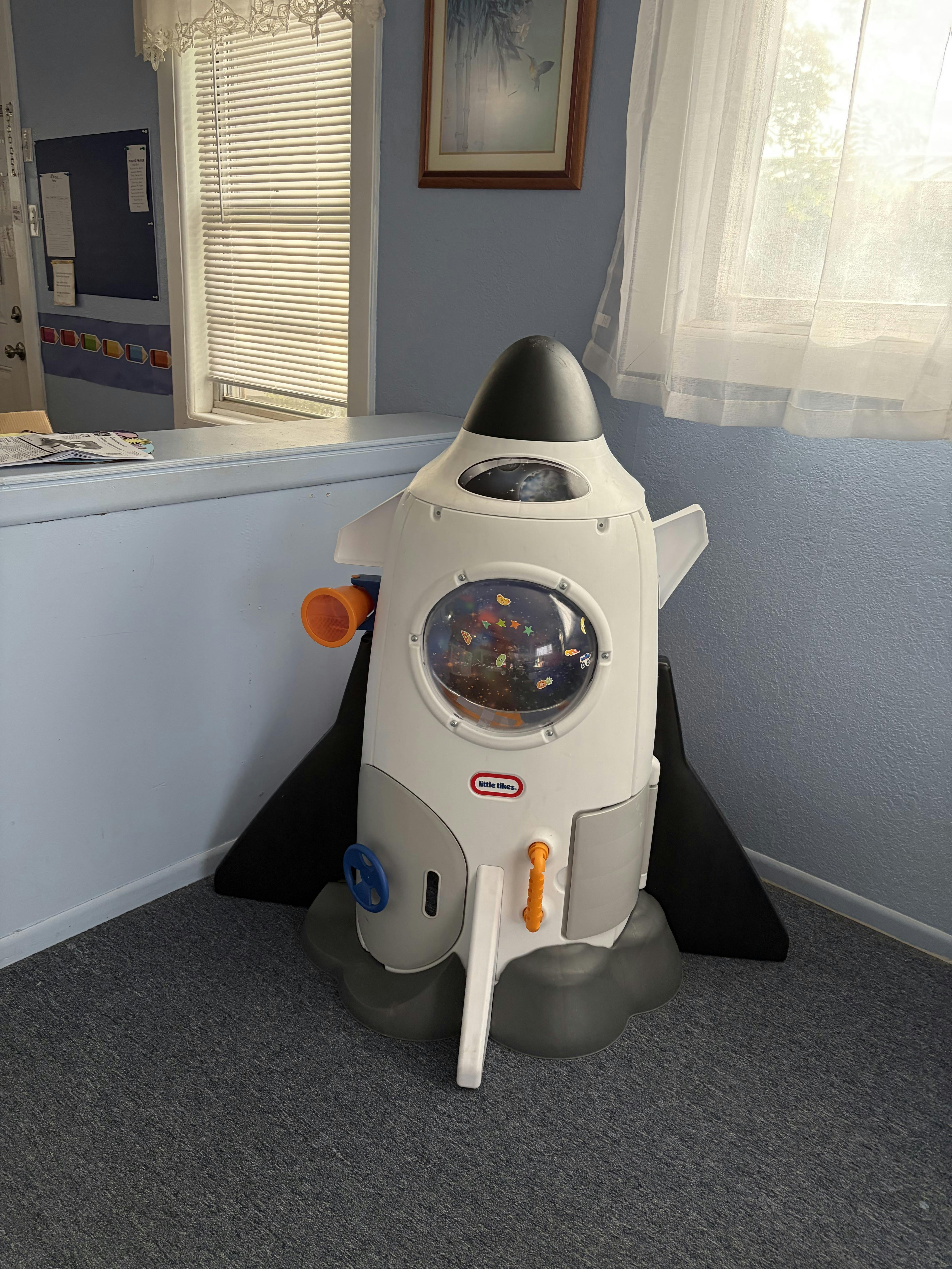 Little Tikes toy rocket ship in a room