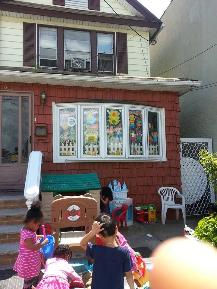 Children playing with toys outside a house