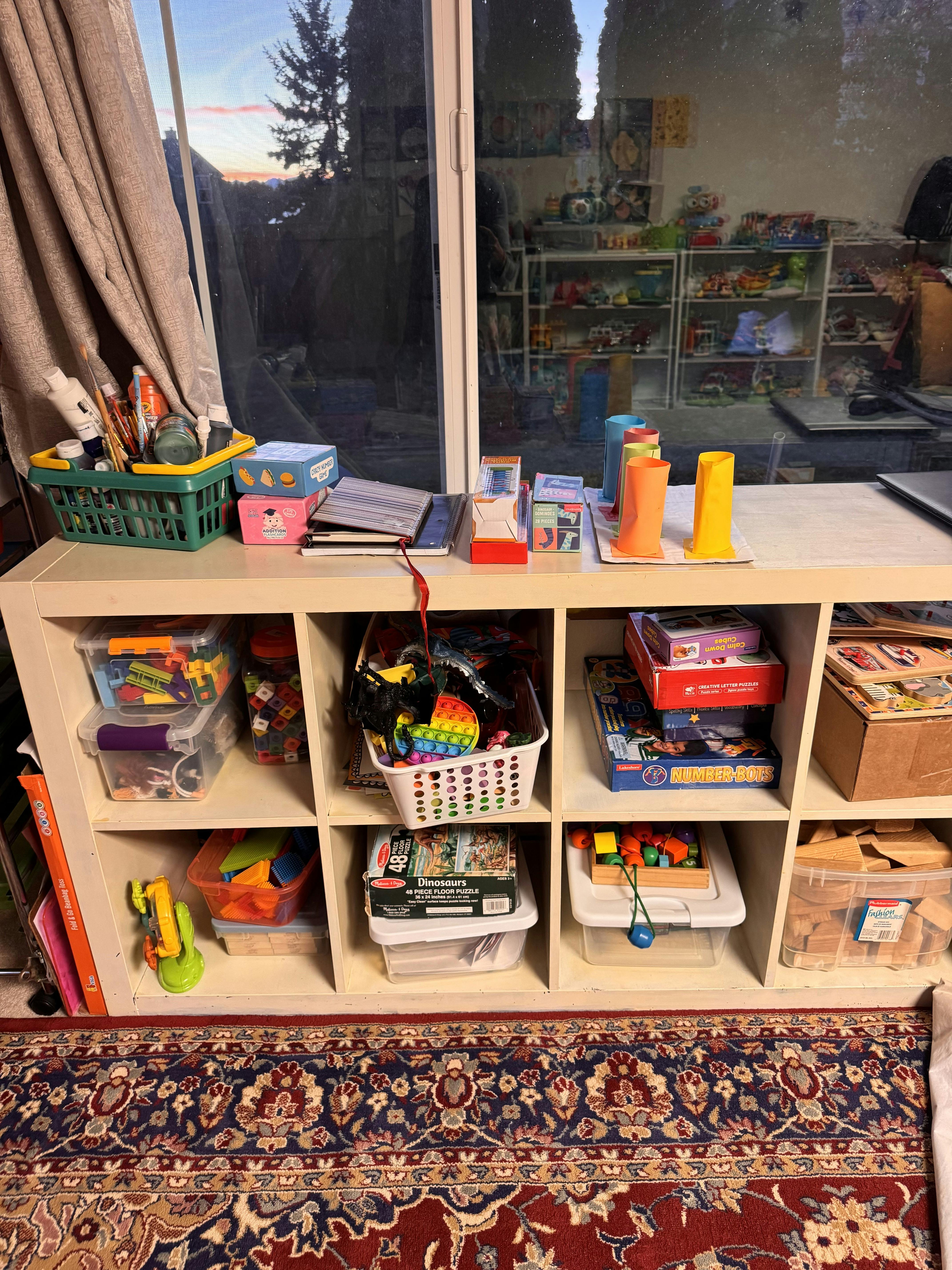 Organized shelving unit filled with children's toys and learning materials