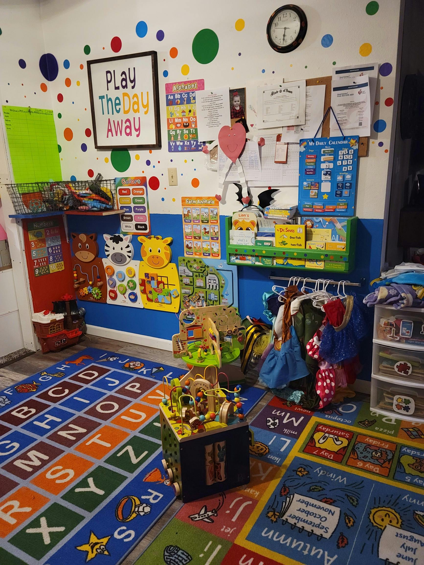 Playroom with colorful alphabet rug, toys, and wall decorations
