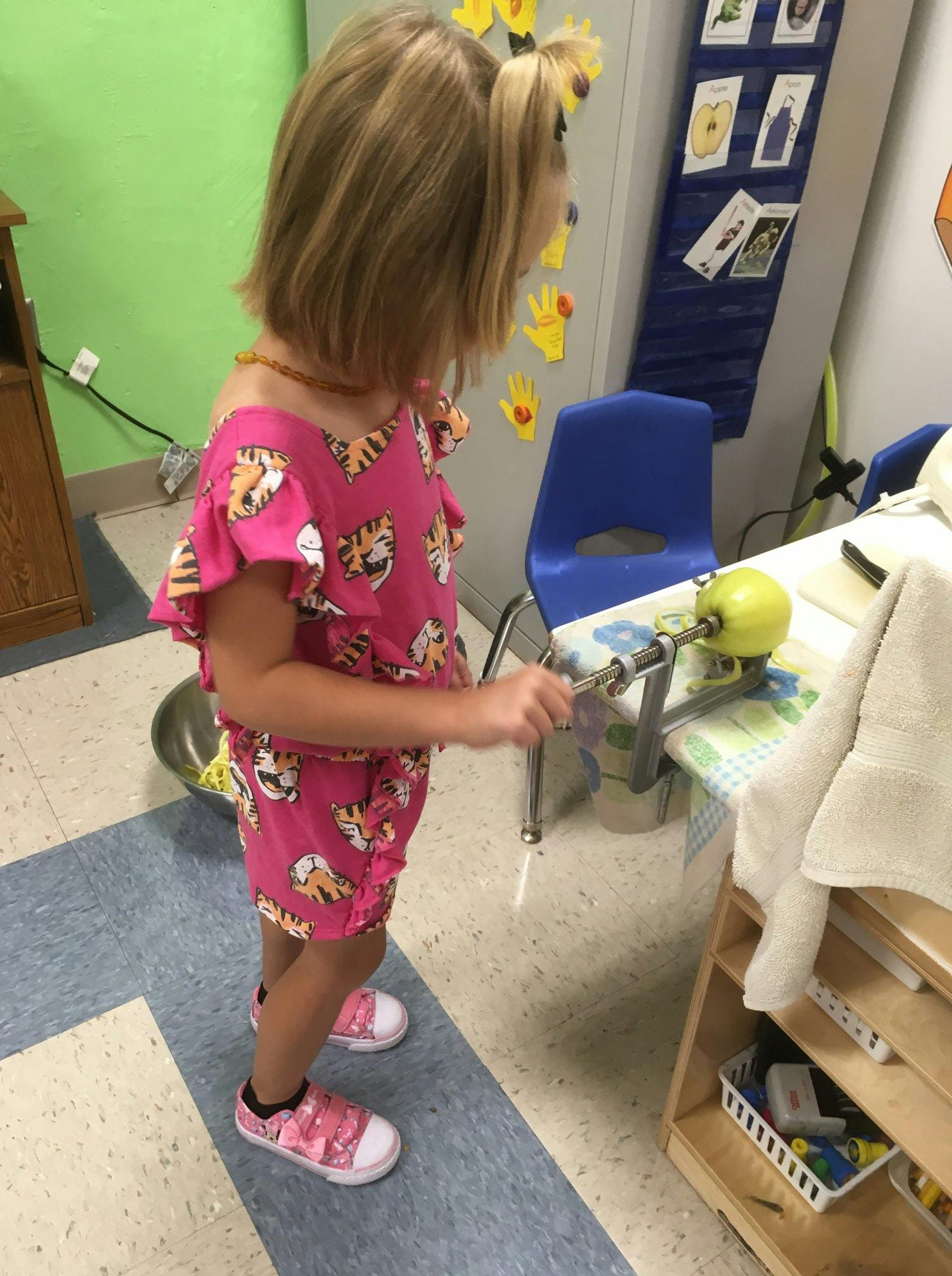 Child using an apple peeler