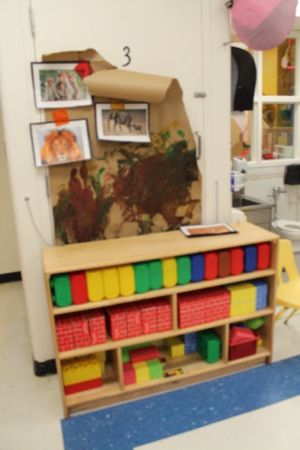 Shelf with colorful bins and boxes in a classroom