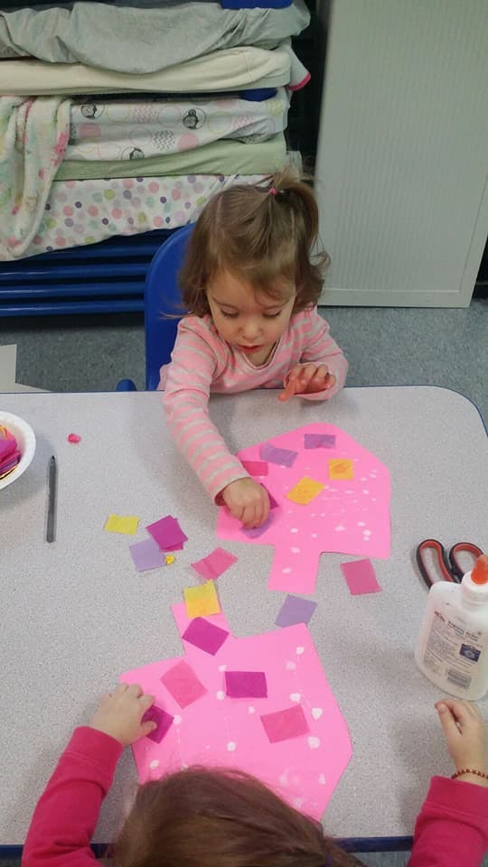 Child doing a craft at a table