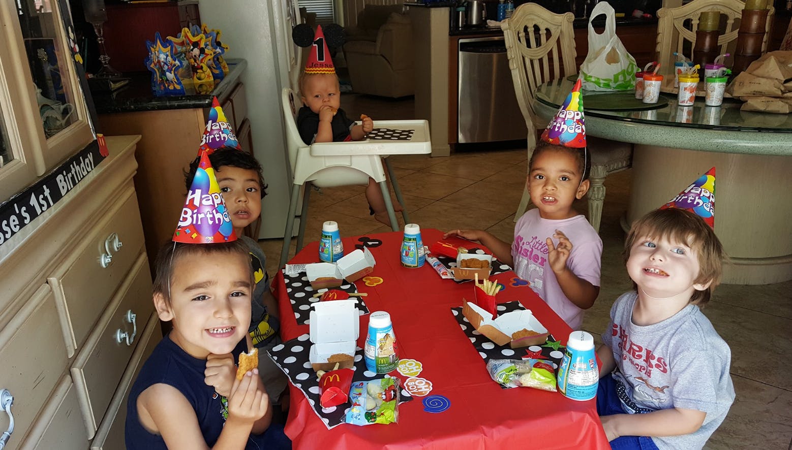 Children wearing party hats at a table