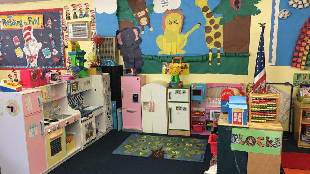 Play kitchen area in a classroom with colorful decorations
