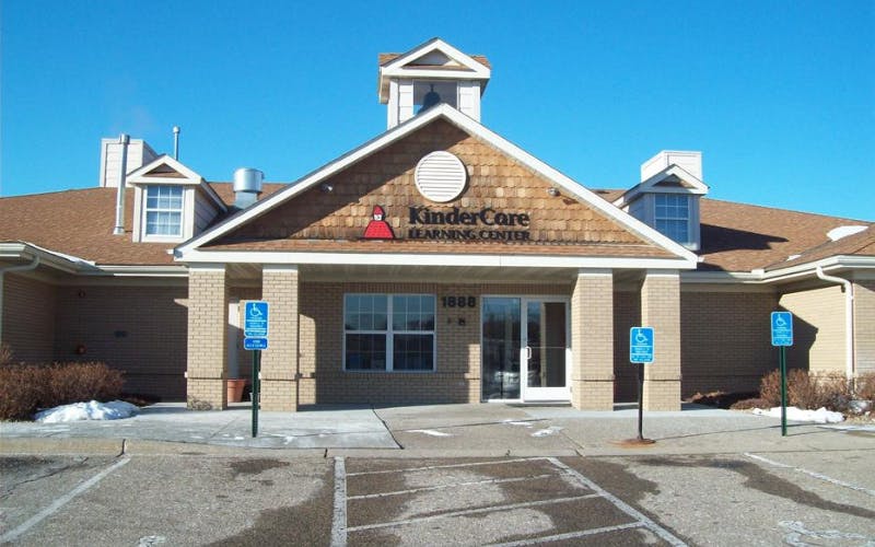 KinderCare Learning Center building with "1888" above the entrance