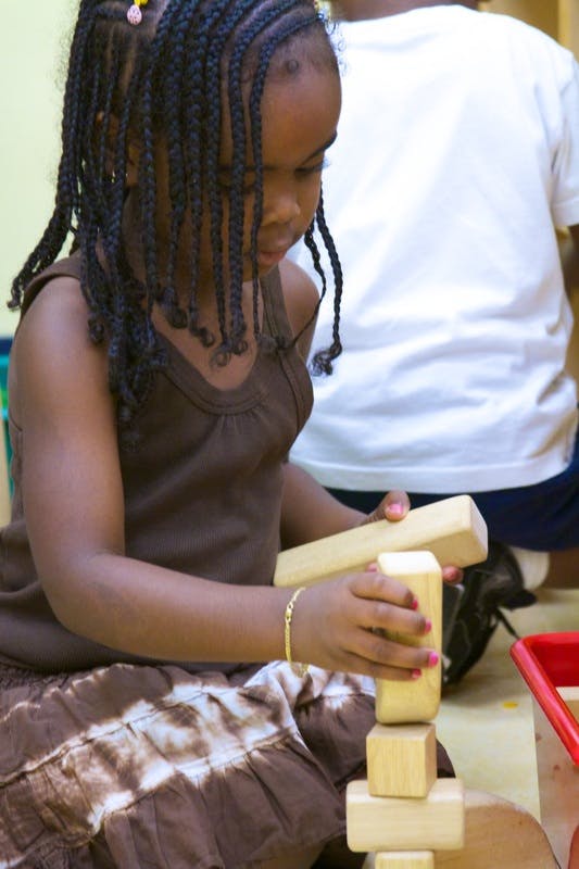 Child building with wooden blocks