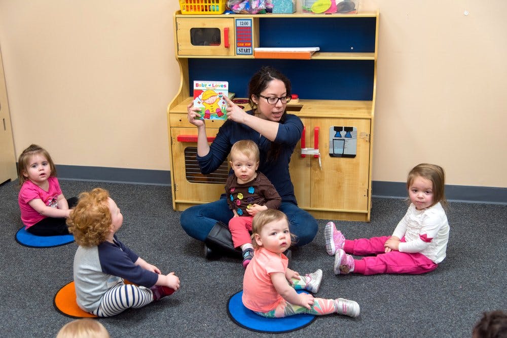 Person reading to children in a classroom