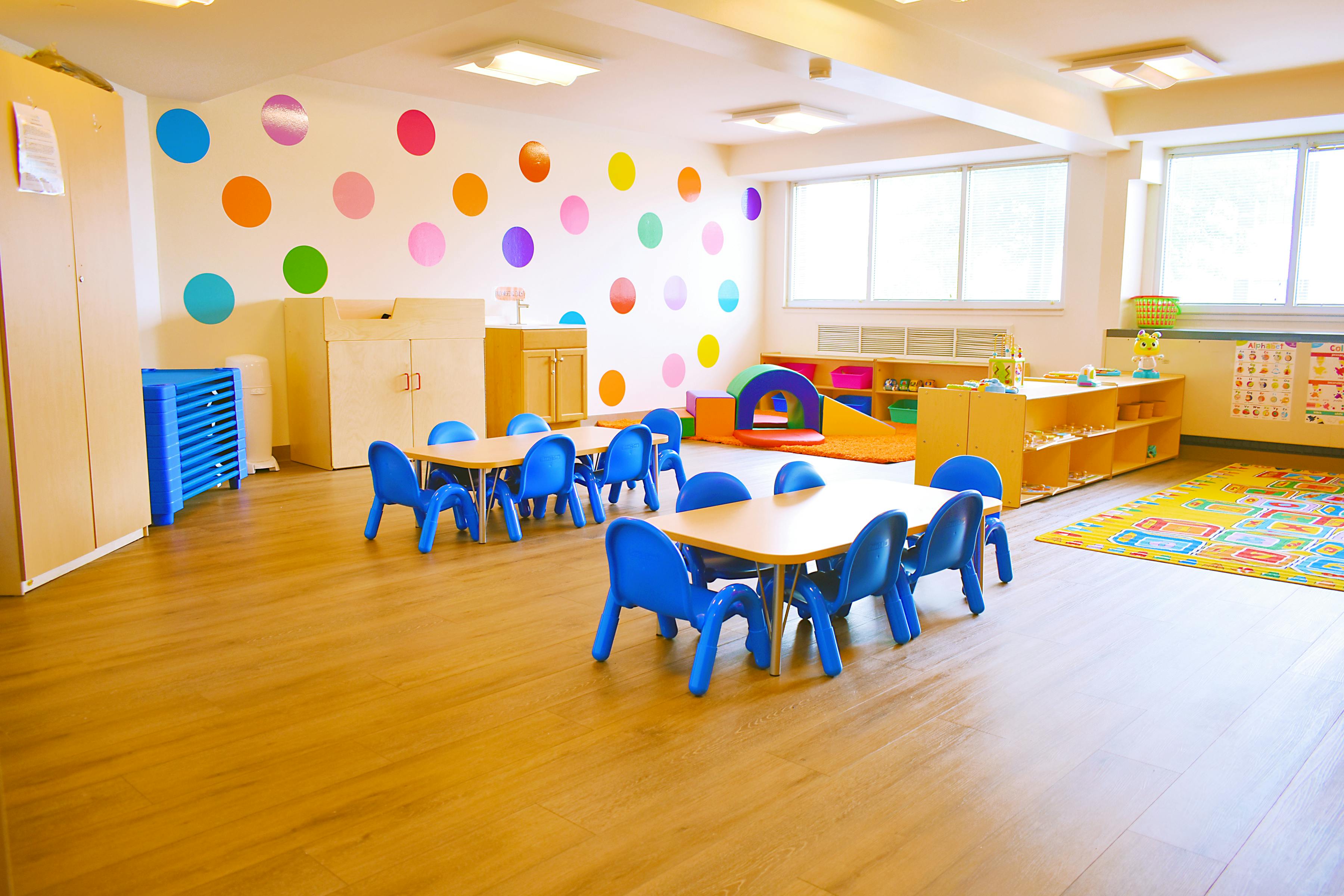 Empty classroom with small tables and blue chairs