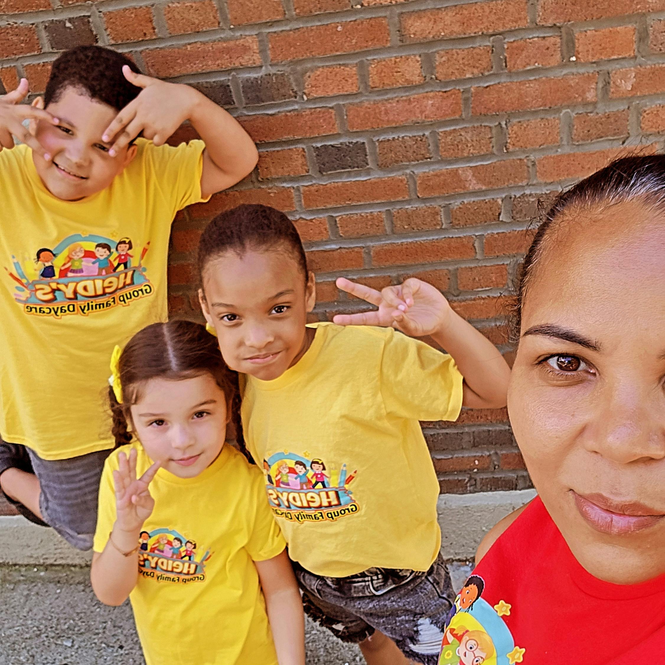 Adult and three children posing for a photo