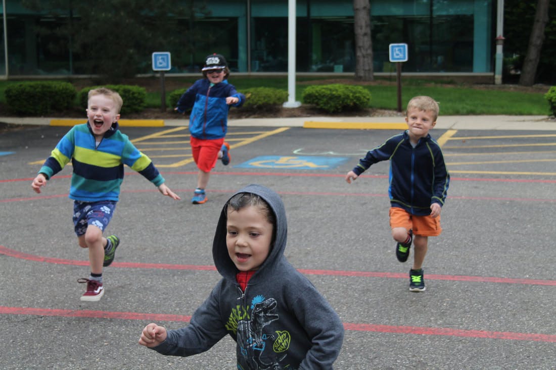 Four children running outdoors
