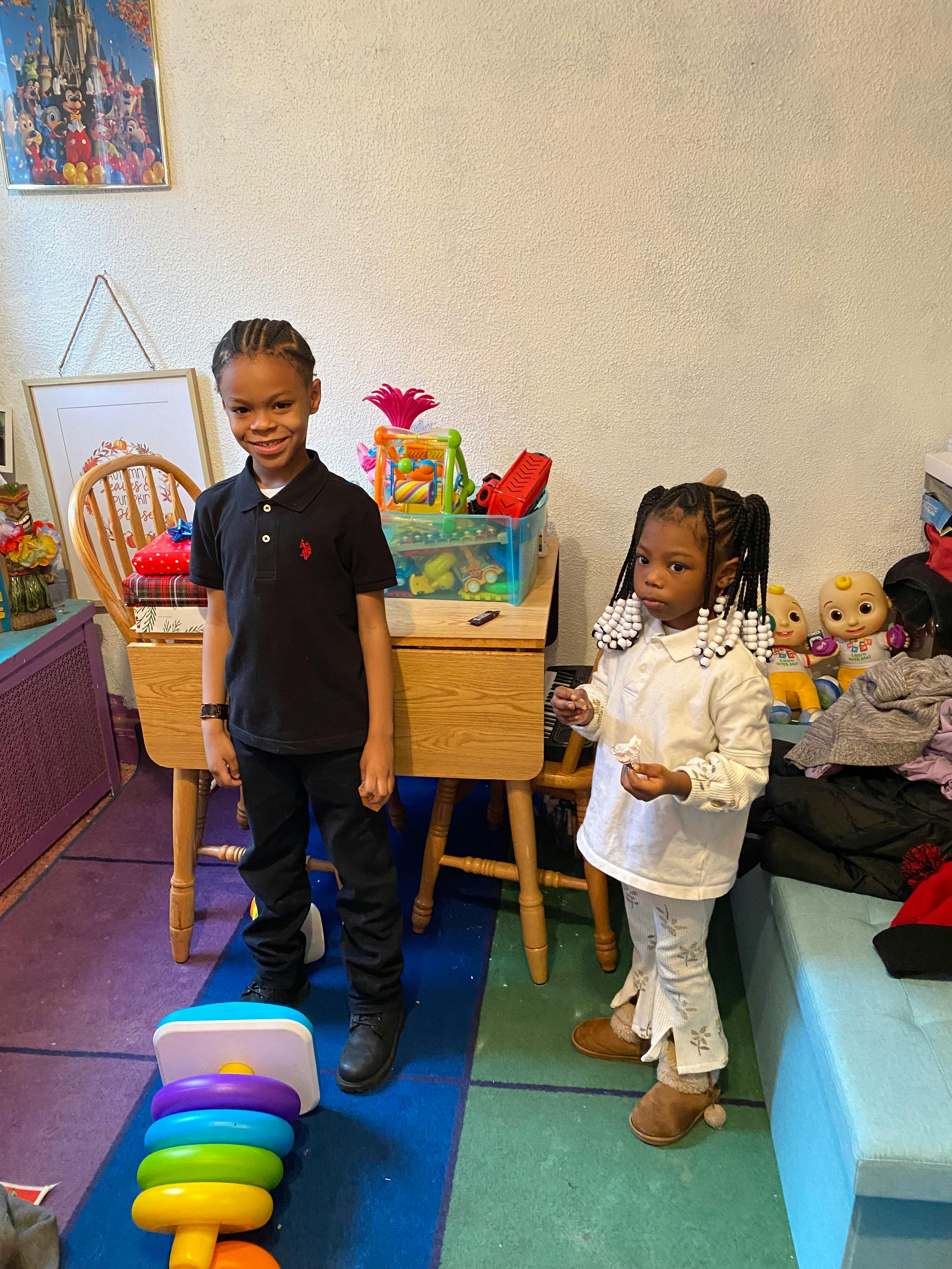 Two children standing in a room