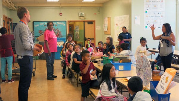 Adults and children in a classroom setting