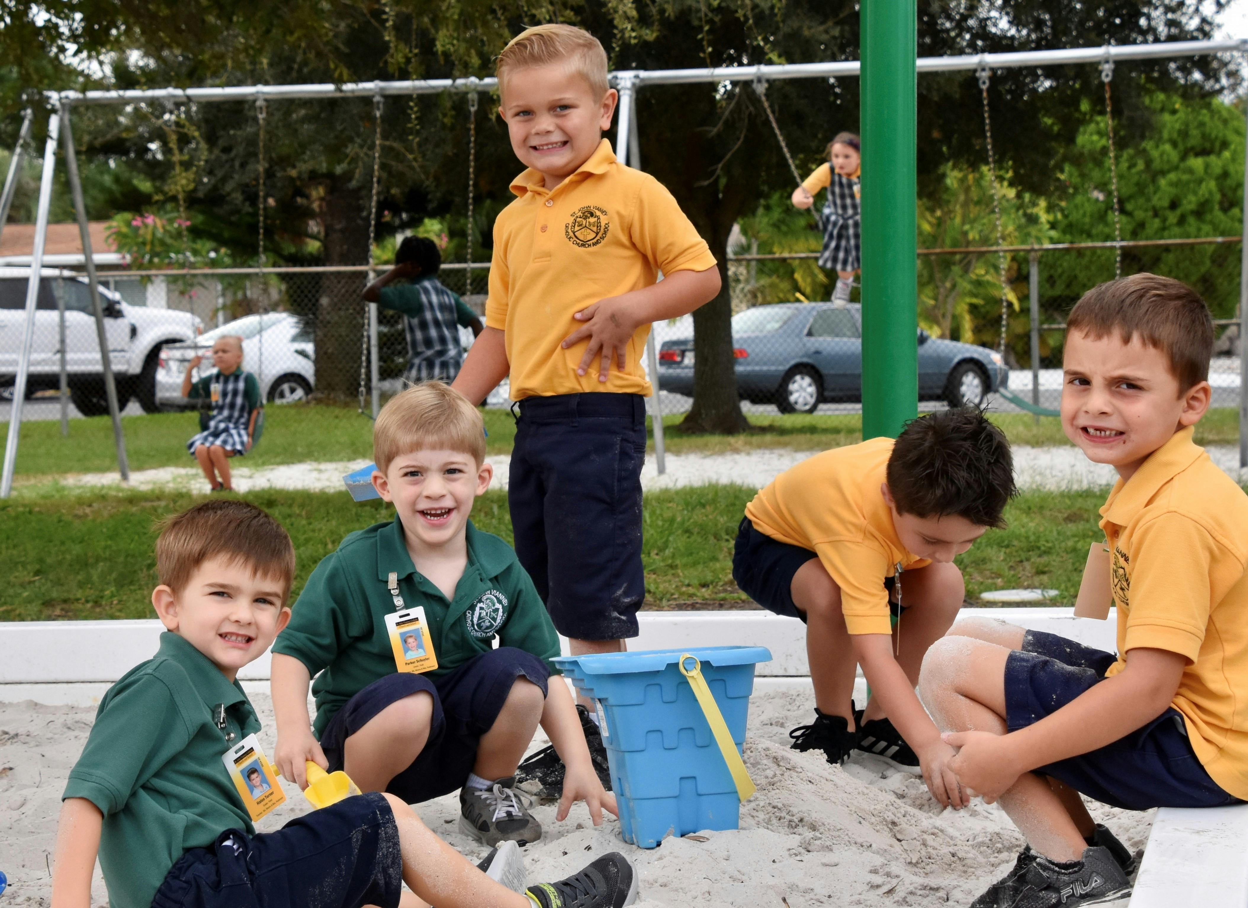 Children playing in a sandbox on a playground