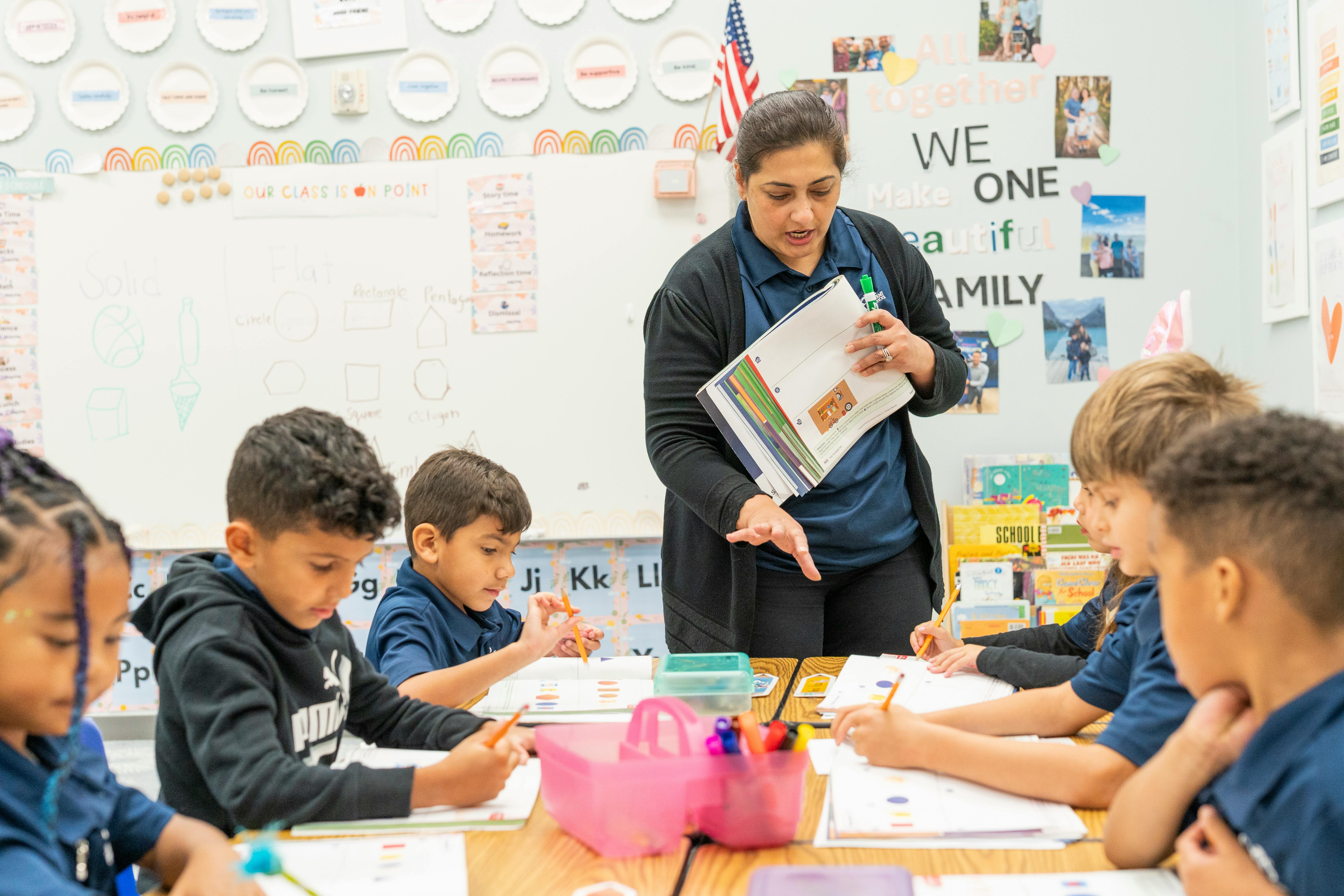 Adult teaching a group of children in a classroom