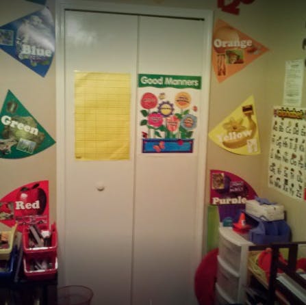 Classroom door with "Good Manners" poster and color-themed decorations