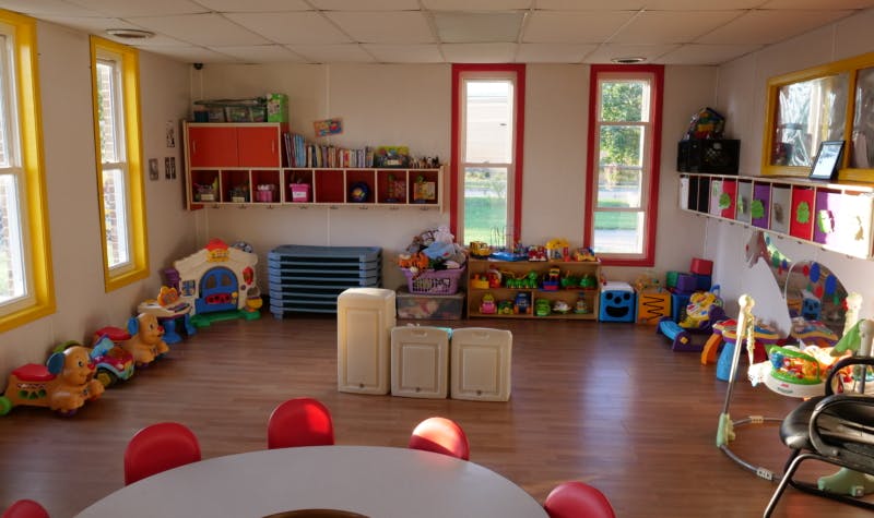 Playroom with toys, shelves, and a table with chairs