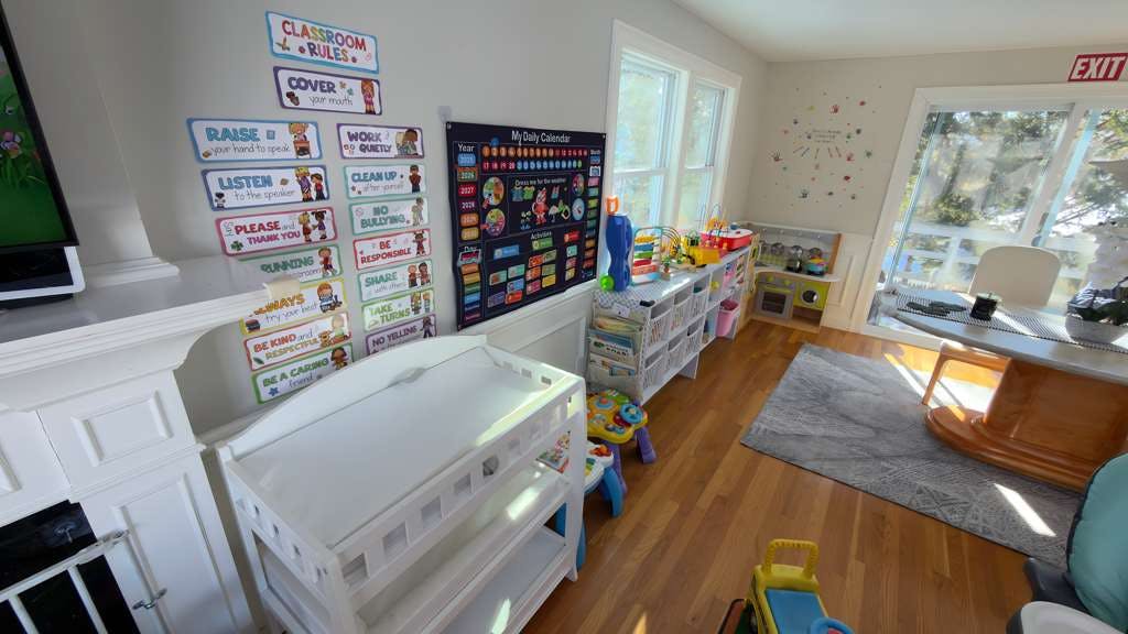 Classroom with rules chart, daily calendar, and play area