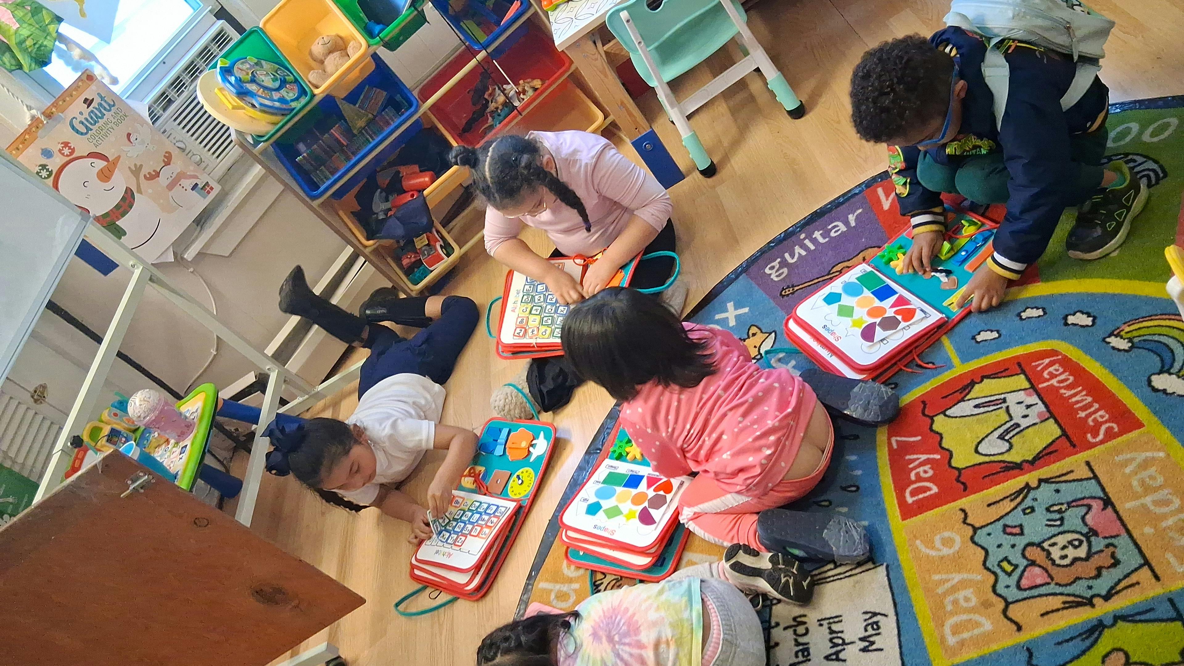 Adult and children playing with toys on a rug