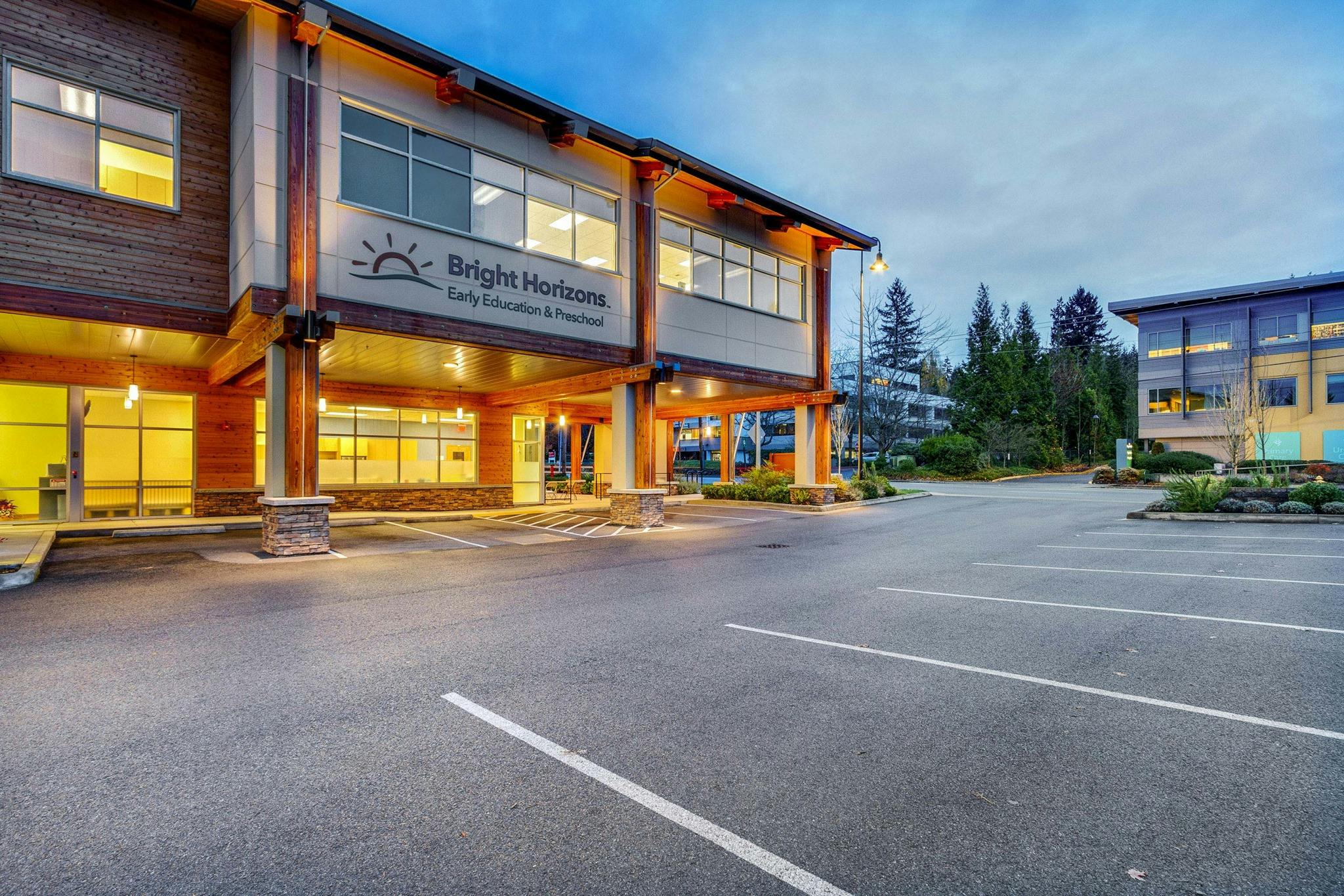 Building with "Bright Horizons" sign and an empty parking lot