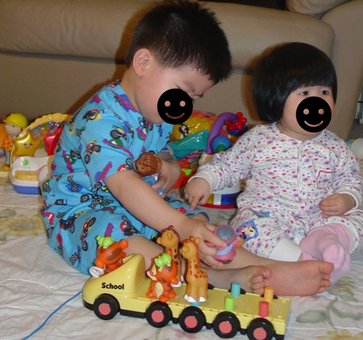 Two children playing with toys on the floor