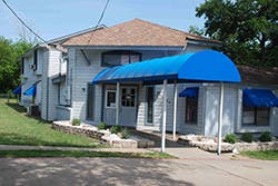 Building with a blue awning over the entrance