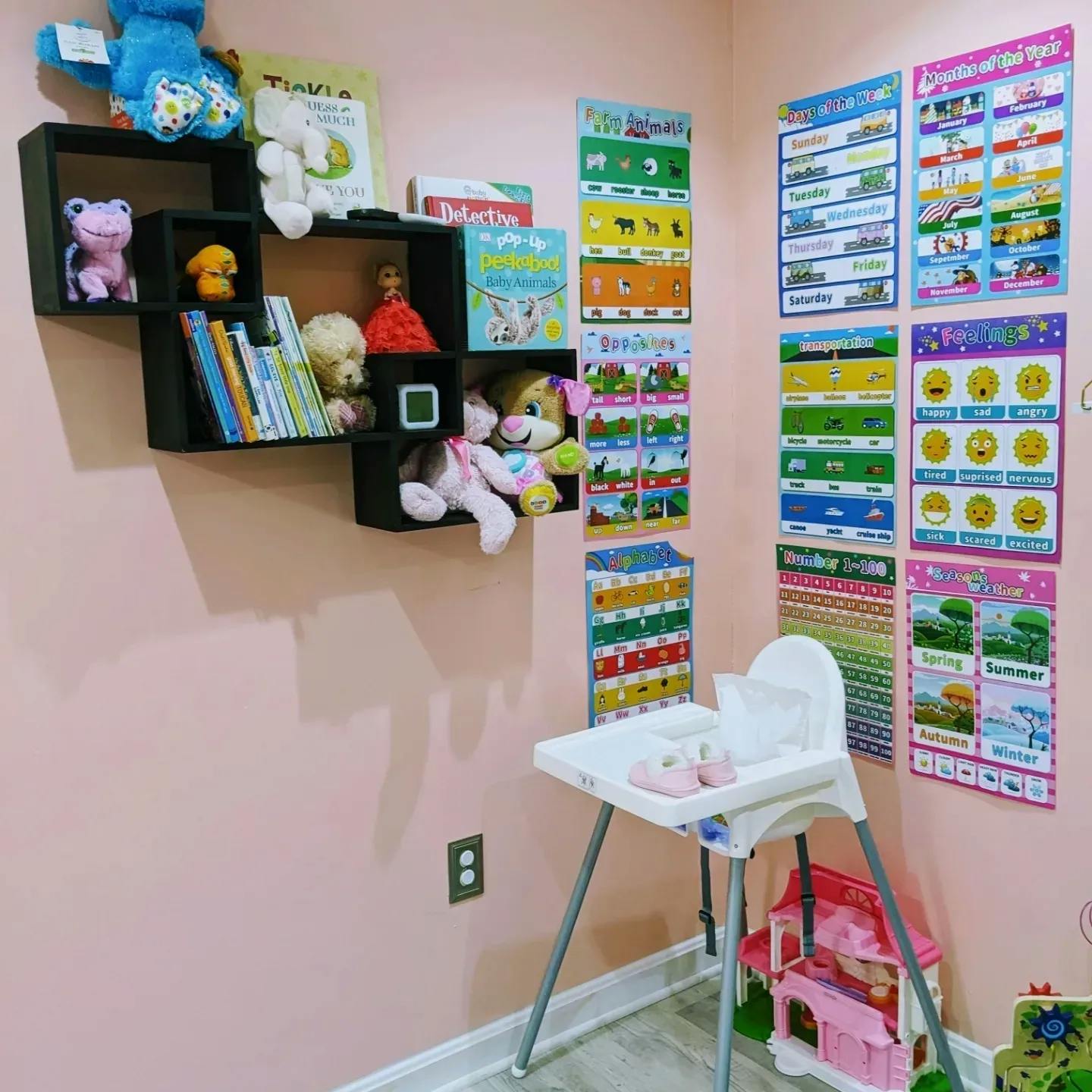 Wall shelves with toys and books, educational posters, and a high chair