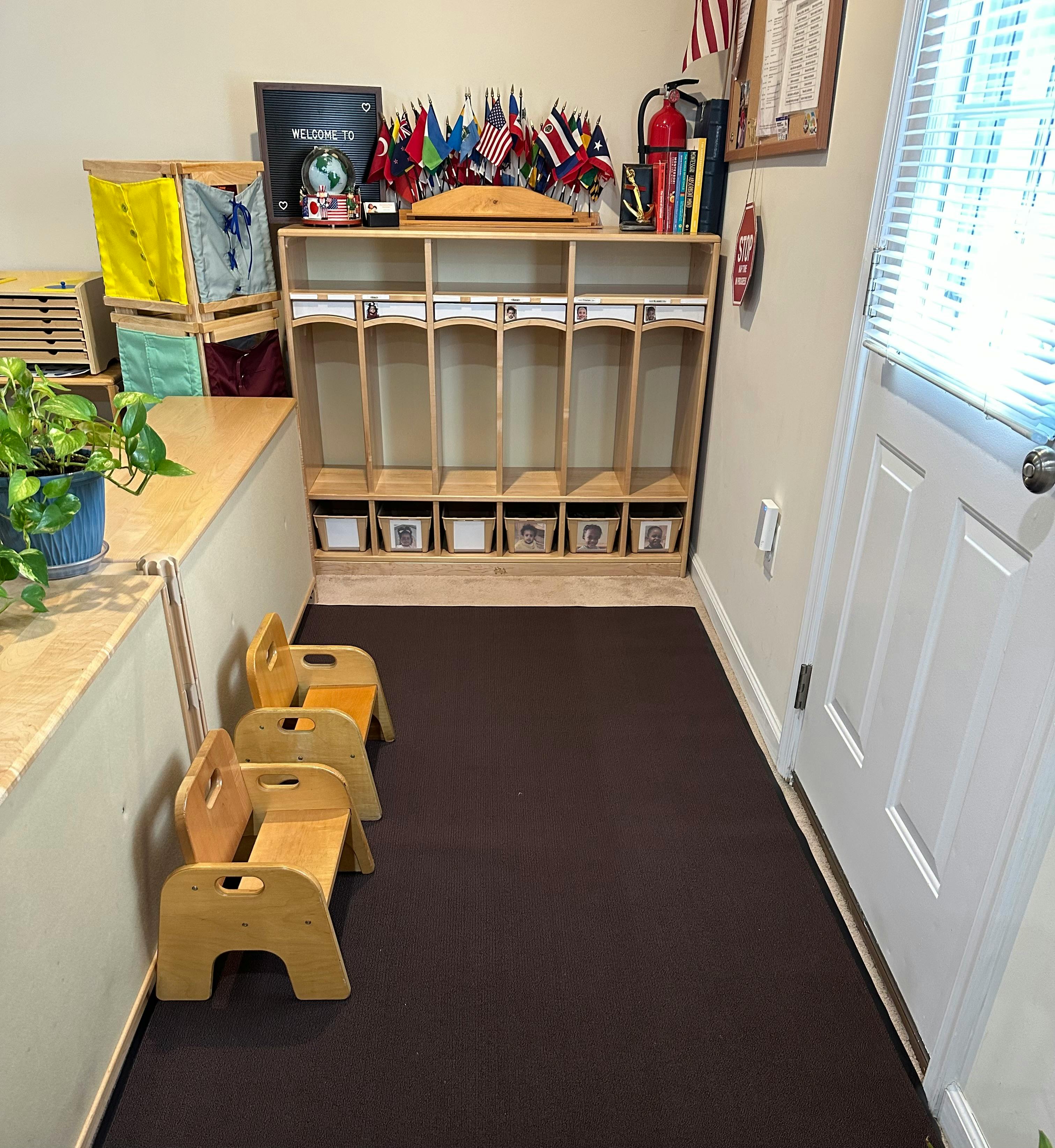 Classroom with cubbies, small chairs, and flags