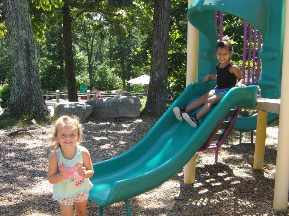 Two children on a playground slide