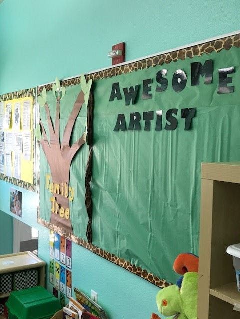 Classroom bulletin board with "Awesome Artist" and "Family Tree" displays