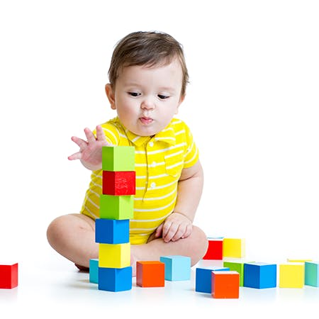 Child playing with colorful building blocks