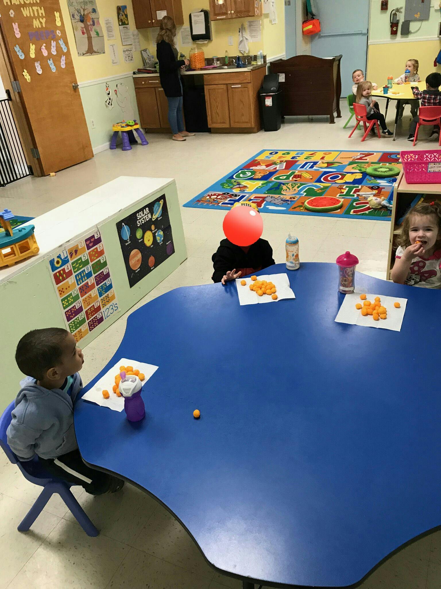 Children sitting at tables in a classroom