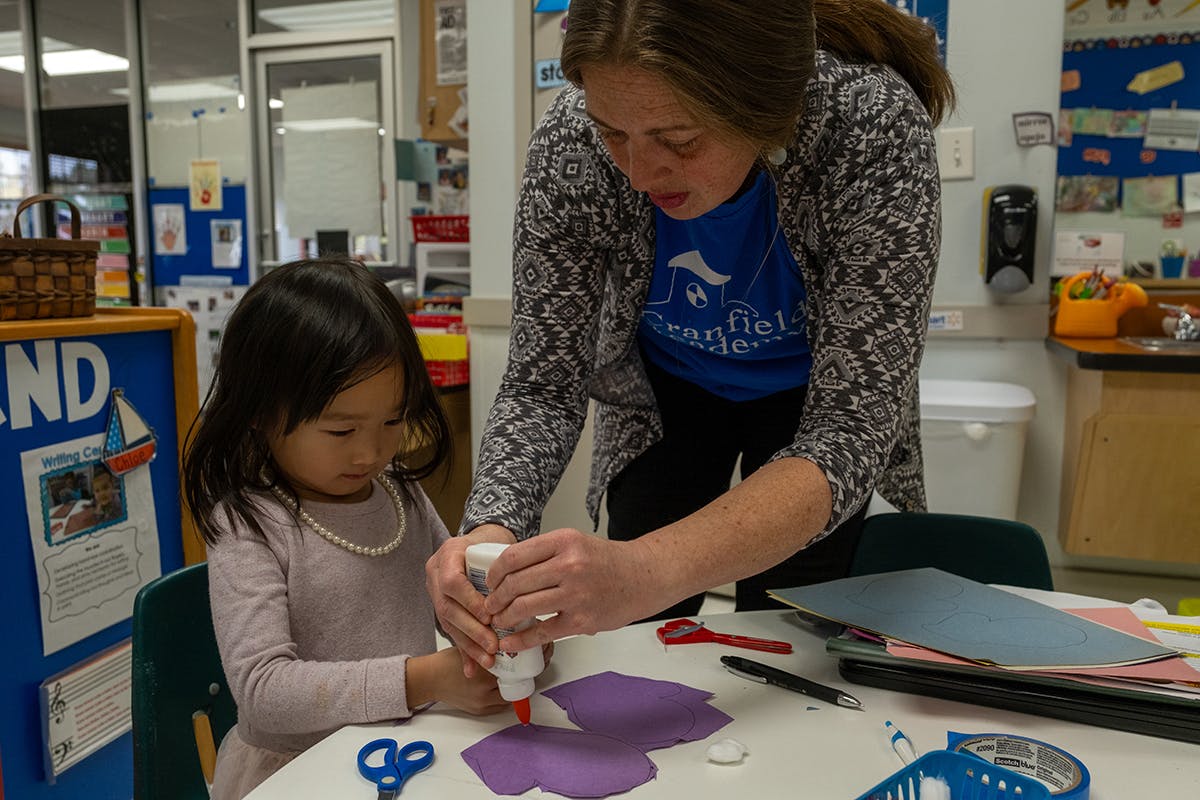 Adult and child doing crafts at a table