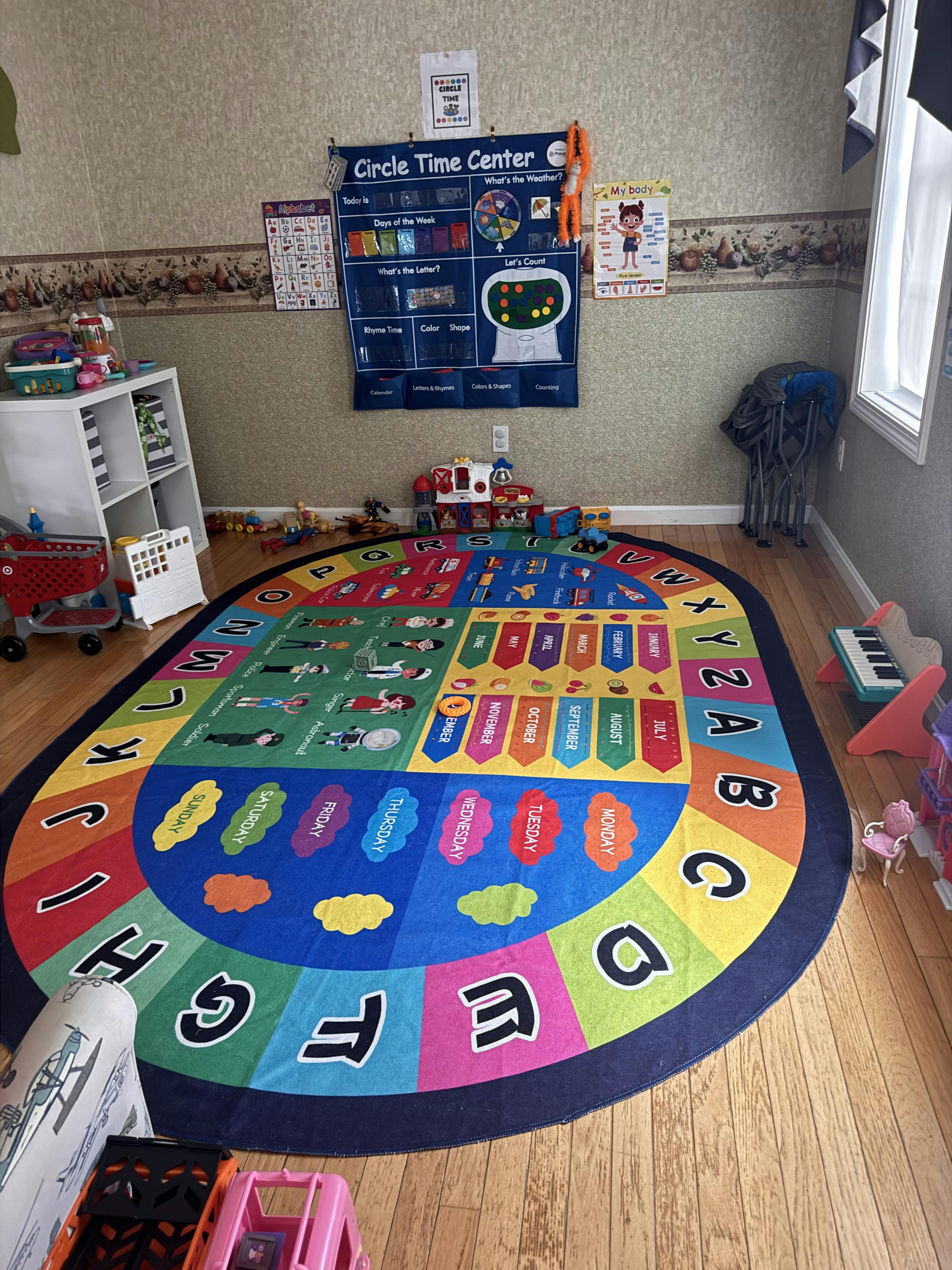 Colorful playroom with an alphabet and calendar rug and a "Circle Time Center" chart
