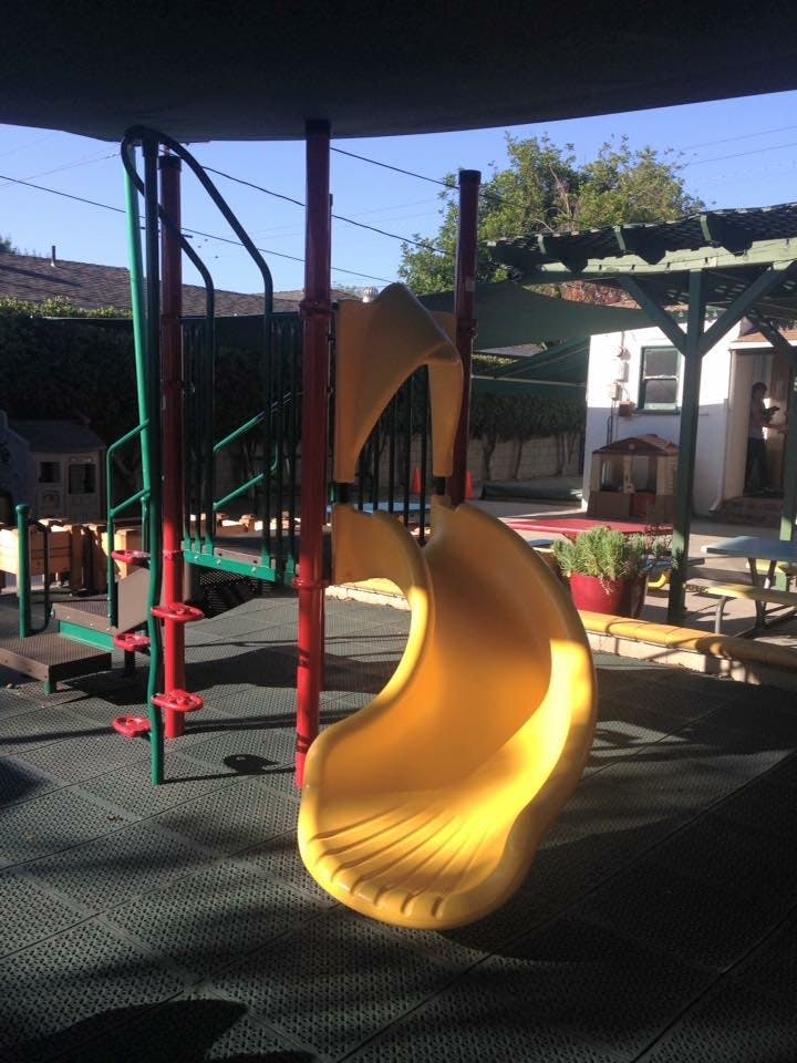 Yellow slide and climbing structure on a playground