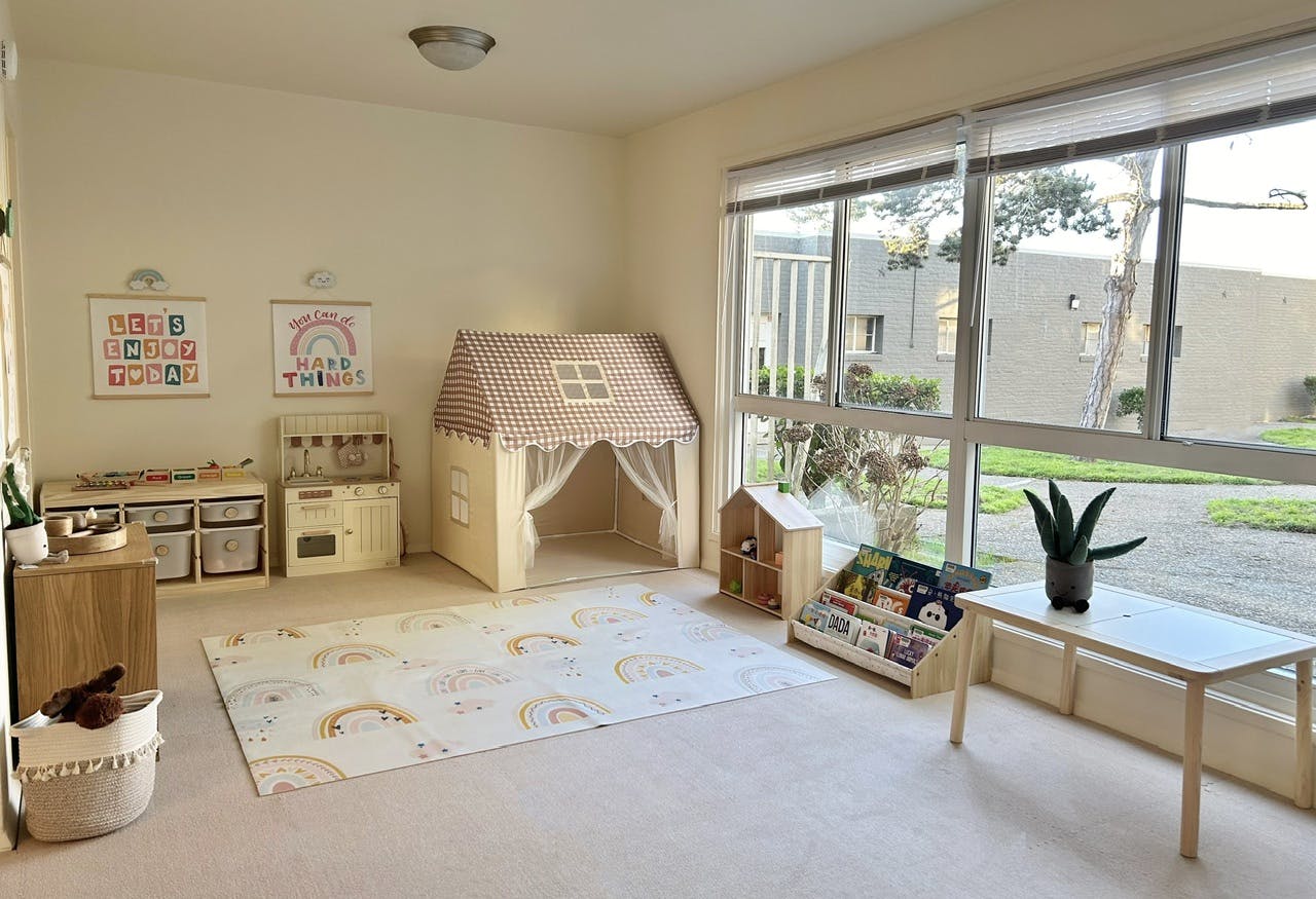 Playroom with a playhouse, rug, and large window
