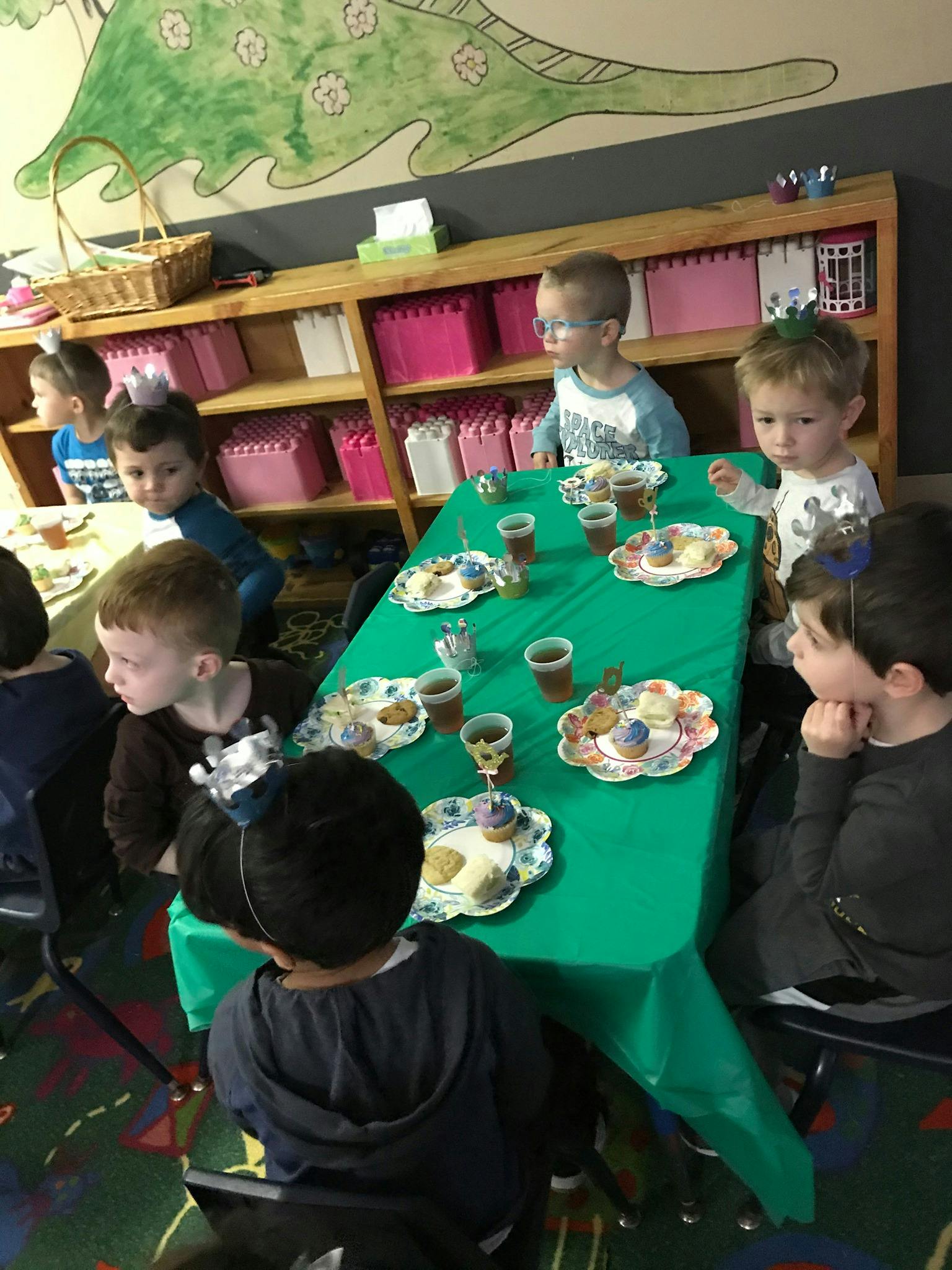 Children sitting around a table with snacks and drinks