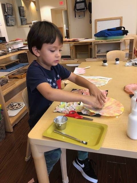 Child doing an art project at a table