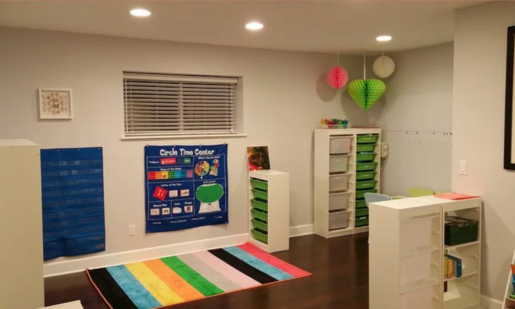 Playroom with colorful rug, window, and storage shelves