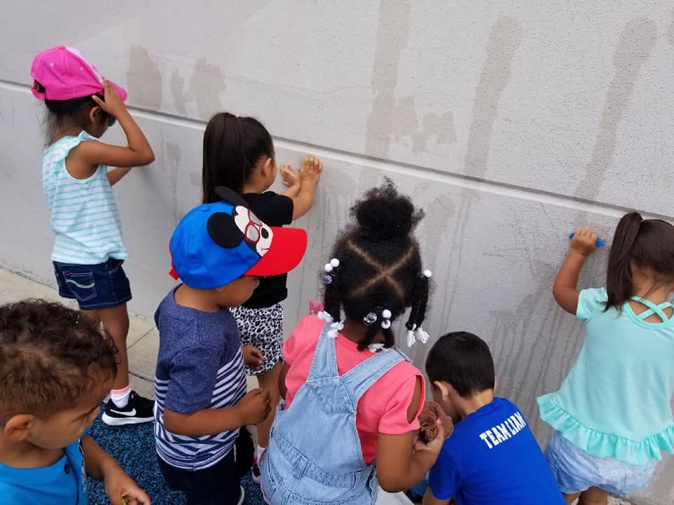 Children painting on a wall