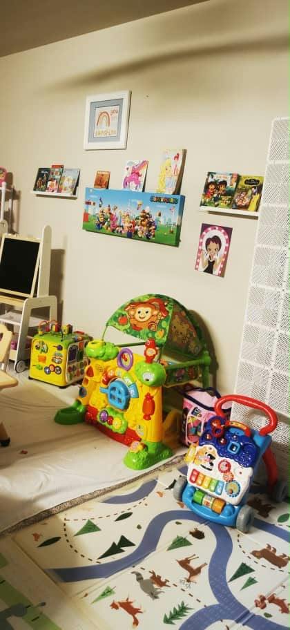 Colorful activity toys and storybooks on shelves in a play area