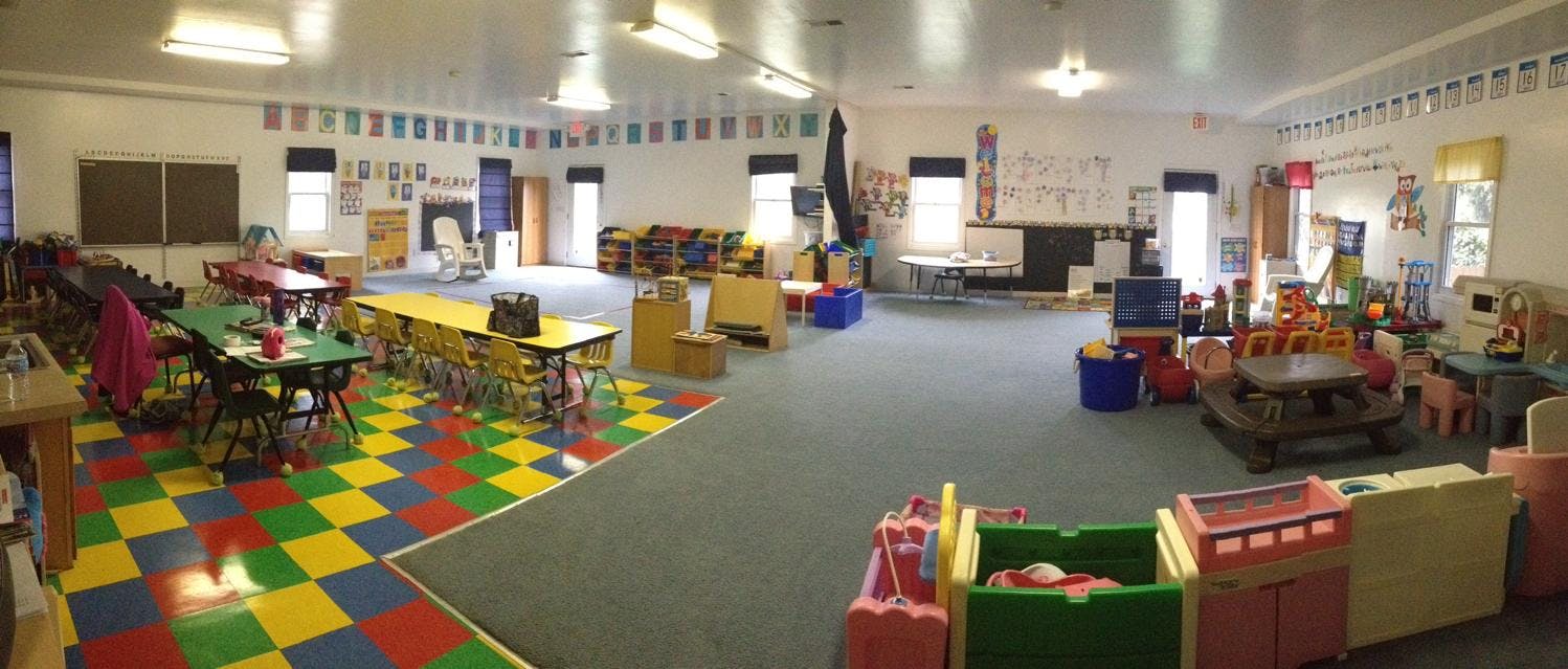 Playroom with colorful checkered floor, tables, and toys