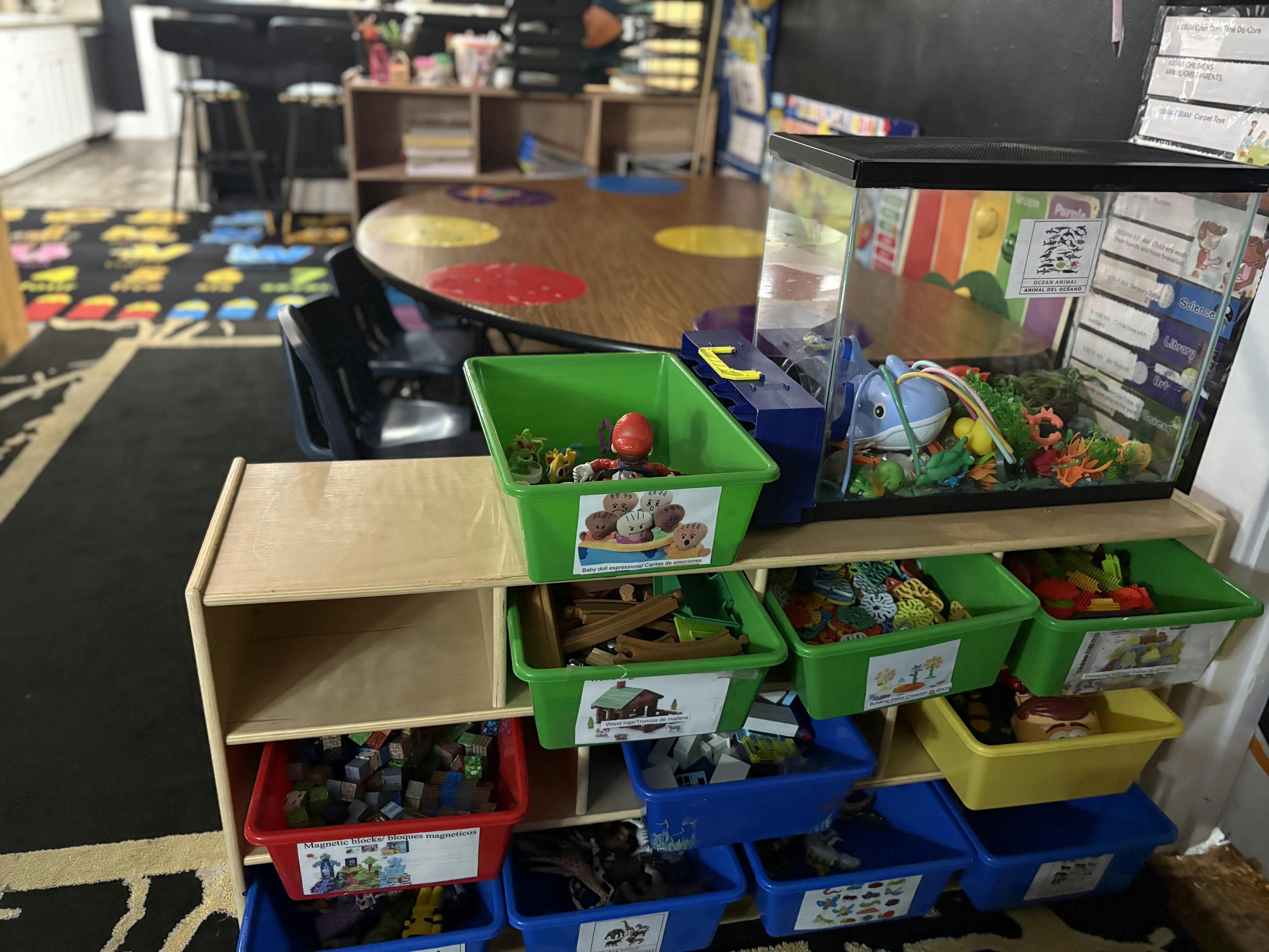 Classroom toy storage shelf filled with various bins of educational toys
