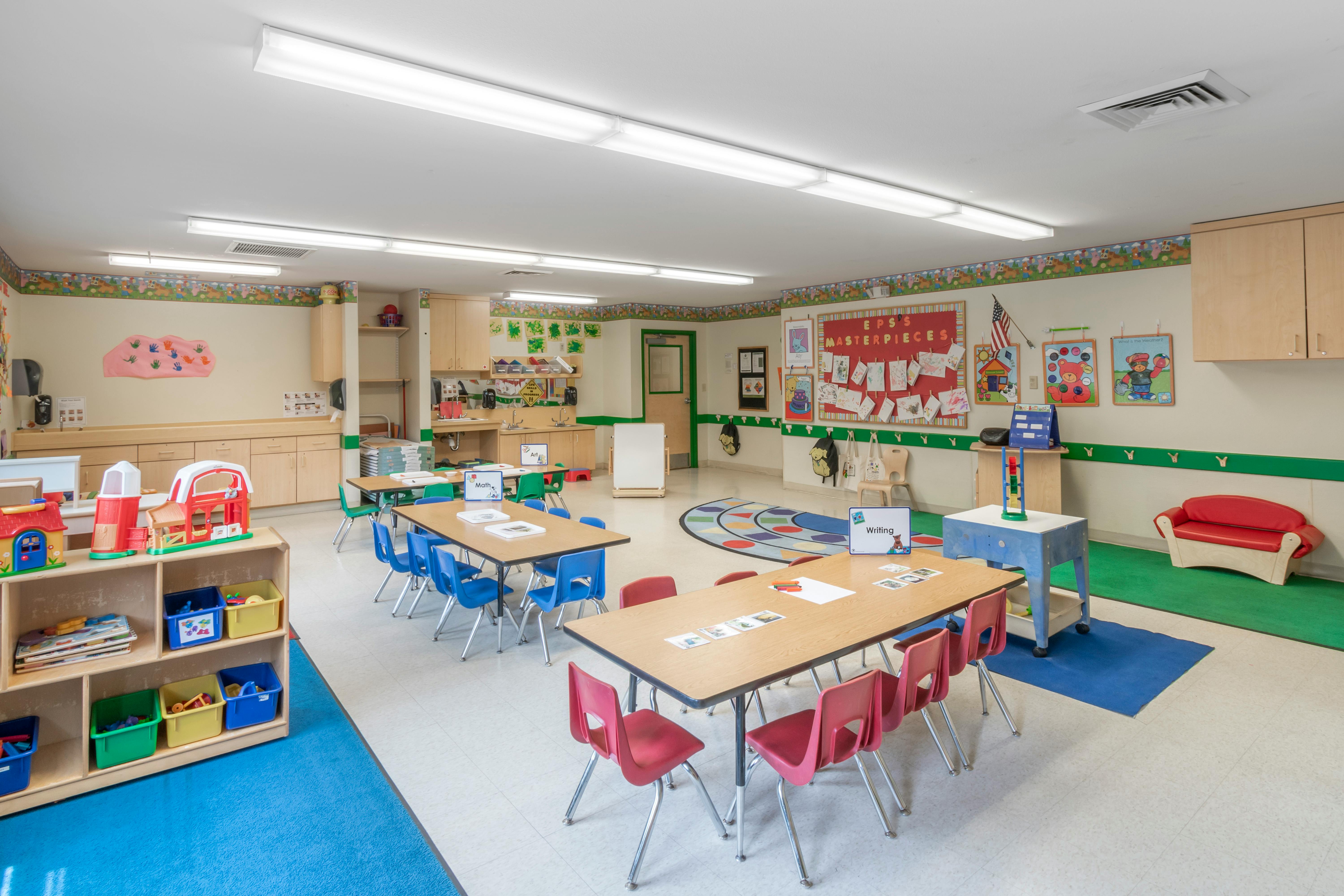 A colorful preschool classroom with small tables and chairs