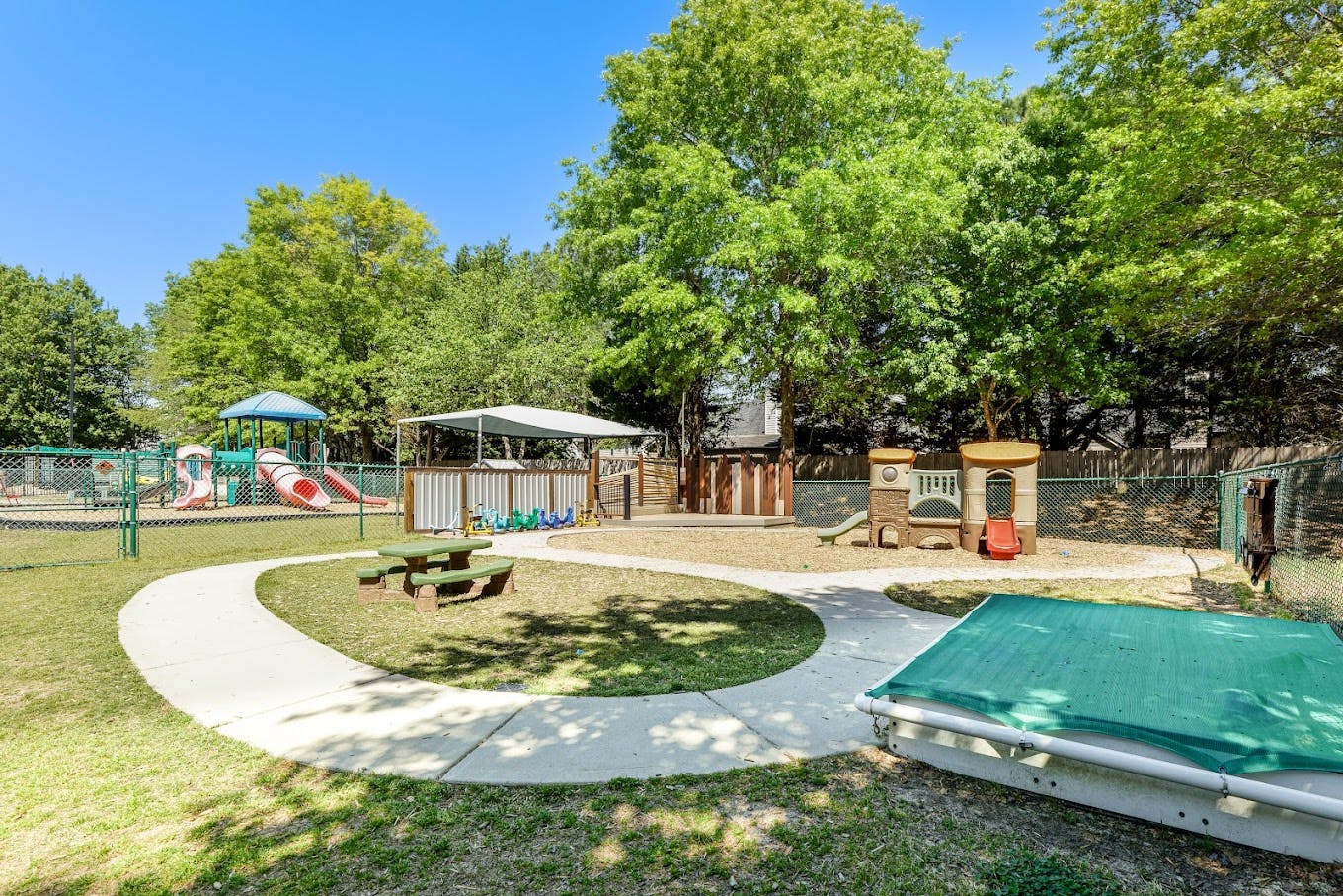 Outdoor playground with multiple play structures and a sandpit