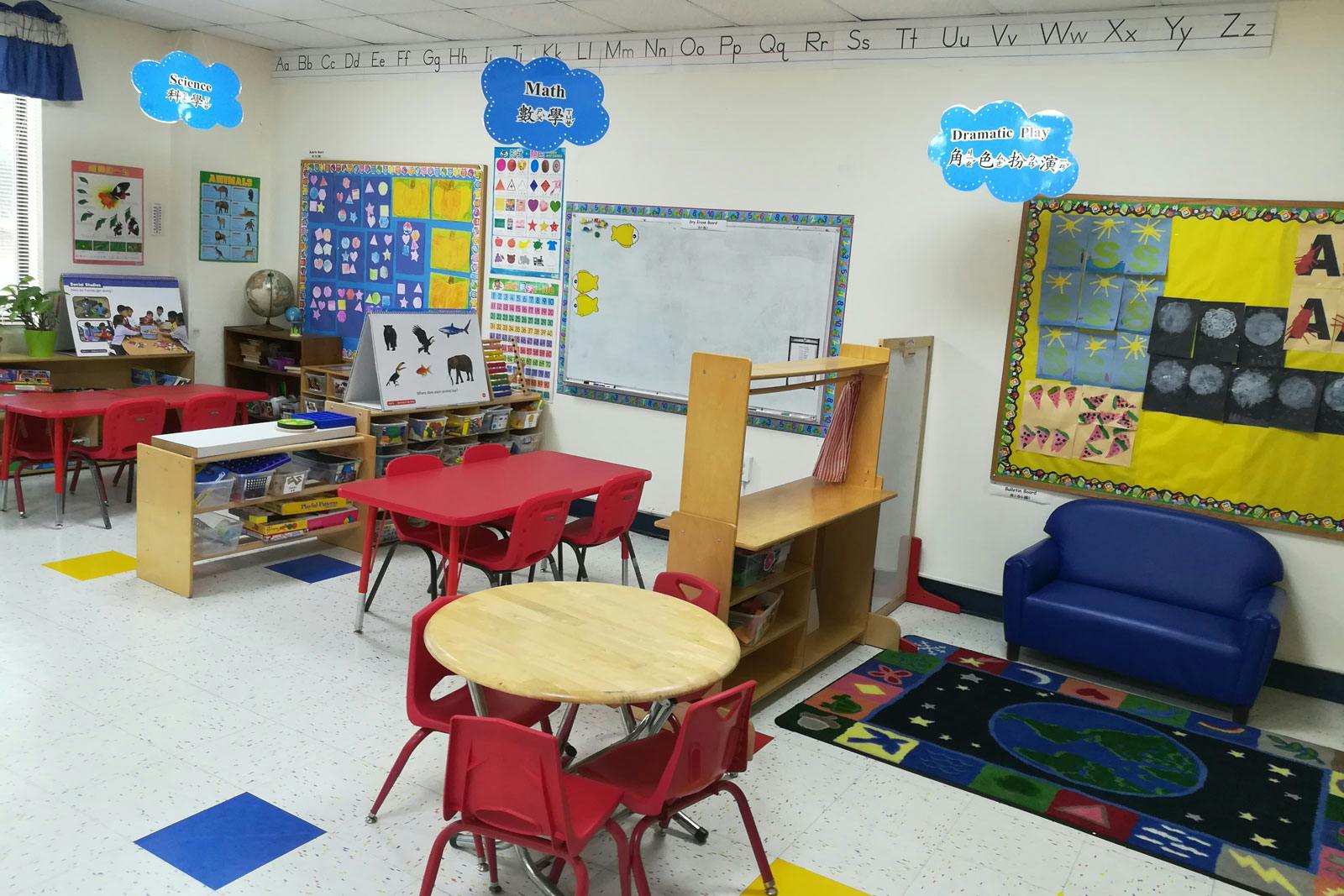 Classroom with small tables and chairs, shelves, and wall decorations