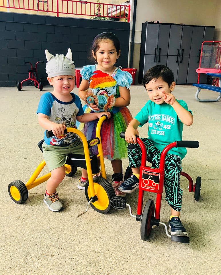 Three children with tricycles