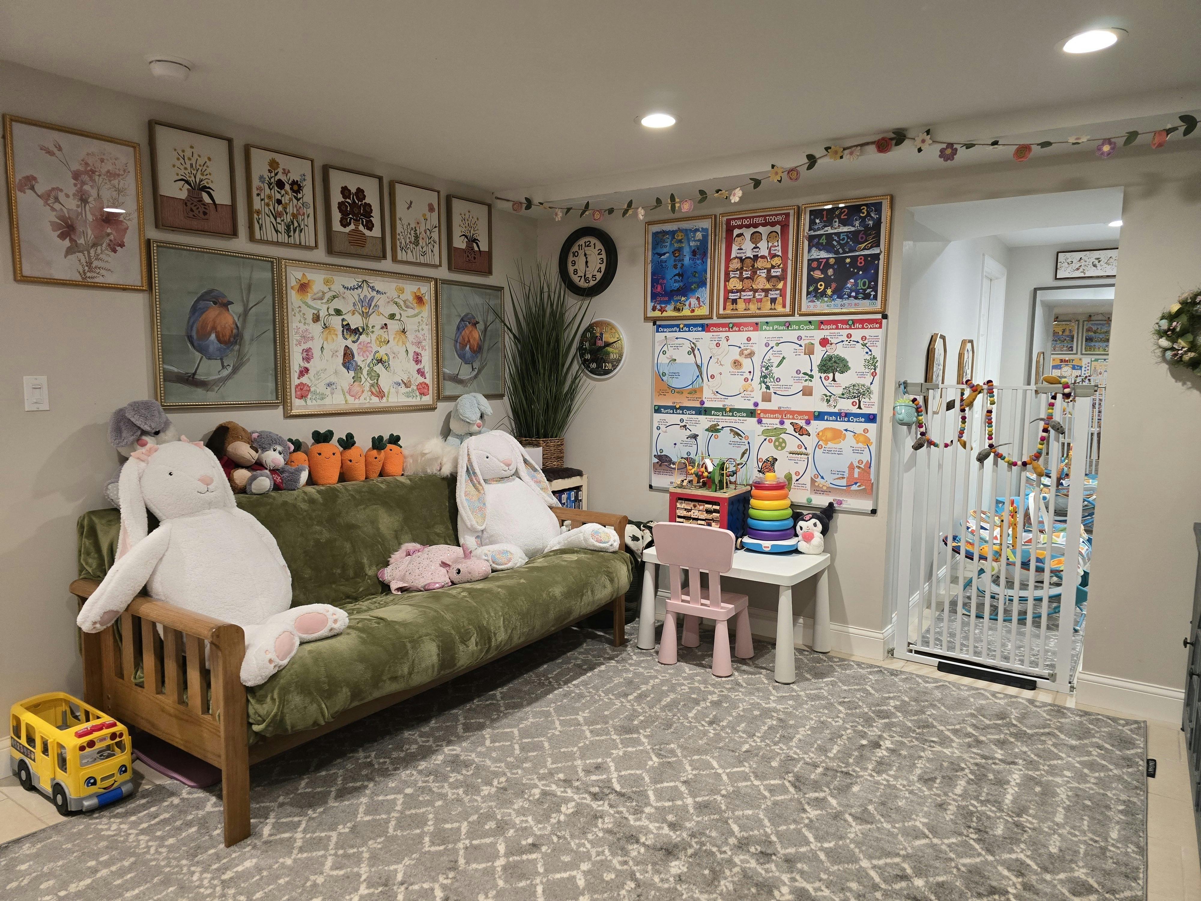 Playroom with a green sofa, stuffed animals, and a crib